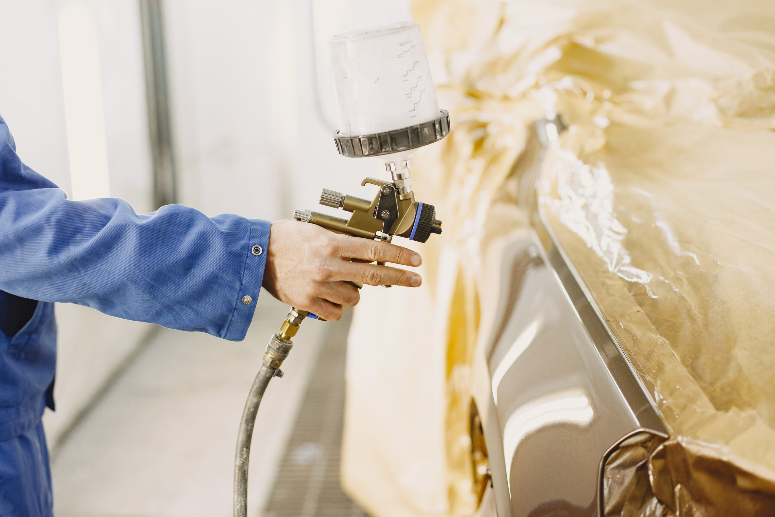 Sanding and painting machine in garage with tools spray painting van panel